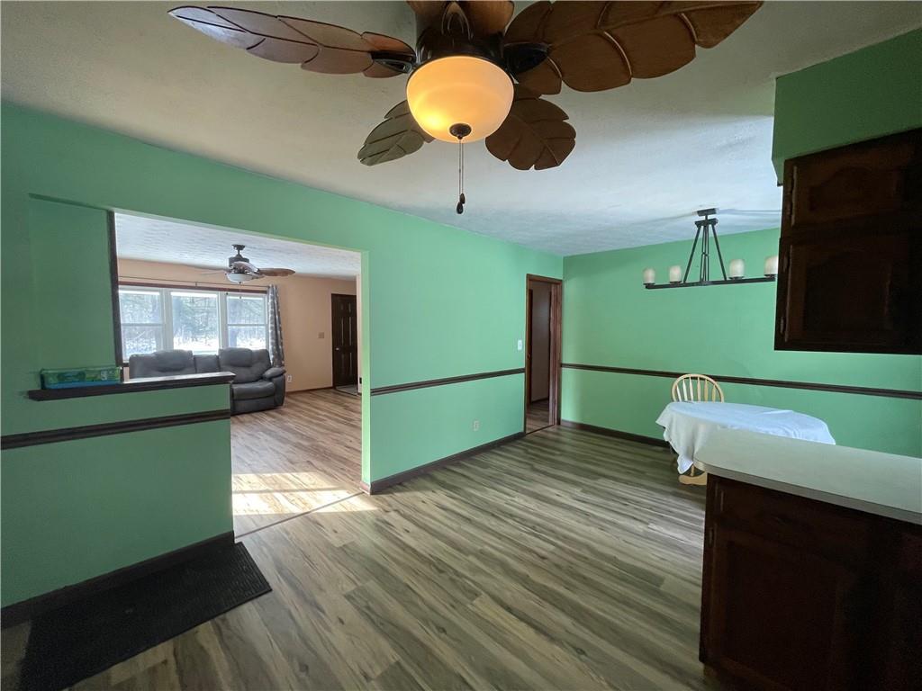 827 Georgetown Road Sandy Lake, PA 16145 - Photo 3 of 20 a kitchen with stainless steel appliances wooden floor dining table and a microwave