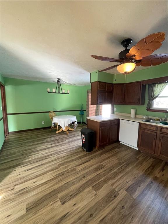827 Georgetown Road Sandy Lake, PA 16145 - Photo 4 of 20 a kitchen with a sink dishwasher and a stove with wooden floor