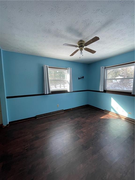 827 Georgetown Road Sandy Lake, PA 16145 - Photo 10 of 20 an empty room with wooden floor and windows