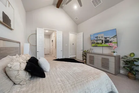 a bedroom with a bed and a chandelier