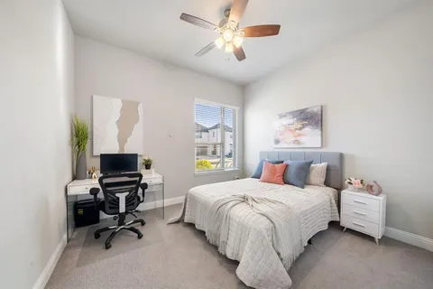 a bedroom with a bed and a desk
