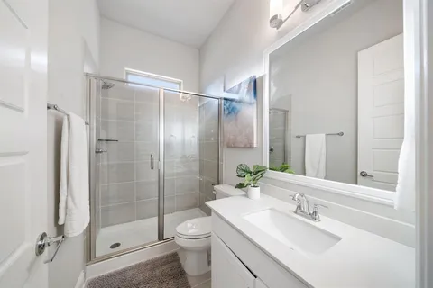 a bathroom with a sink toilet and shower