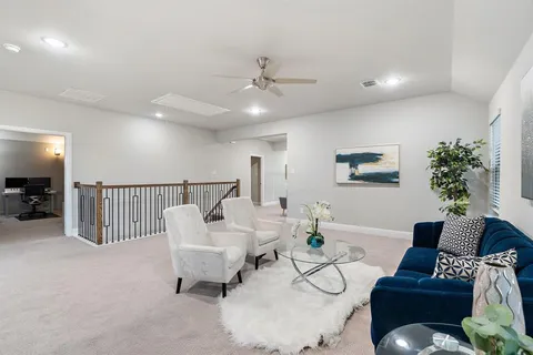 a living room with furniture and a potted plant