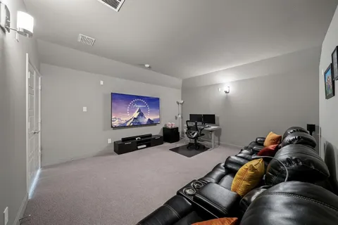 a room with furniture gym equipment and a chandelier