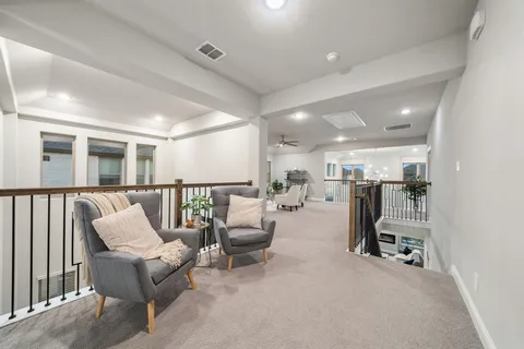 a hallway with a table and chairs