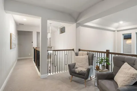 a view of a hallway with couch and windows