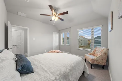a bedroom with a bed and window