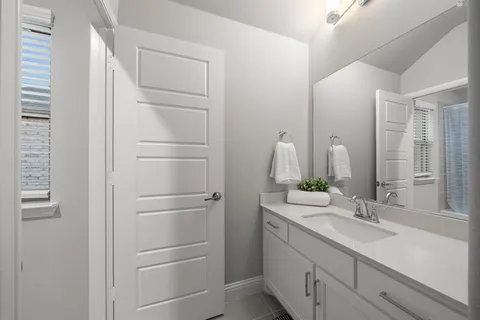 a bathroom with a double vanity sink and a mirror