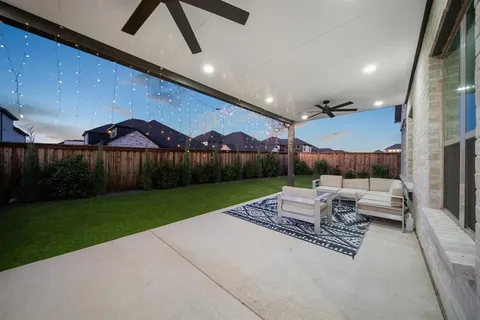 a patio with table and chairs with wooden floor