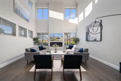 a dining room with furniture a rug and wooden floor