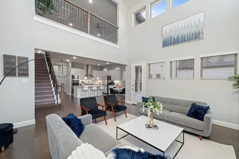 a living room with furniture and a chandelier