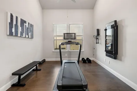 a room with gym equipment and a window