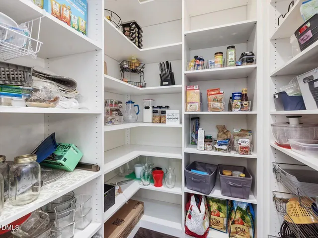 a spacious bedroom with a bed couch and window