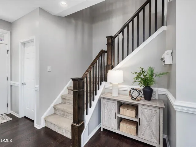 a bathroom with a granite countertop sink toilet and mirror