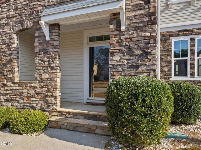 a dining room with furniture a chandelier and wooden floor