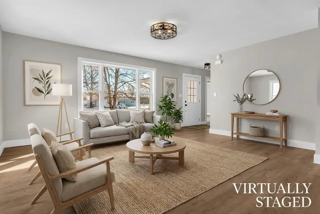 a living room with furniture a table and a large mirror