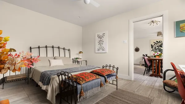 a bedroom with a bed and a table in it