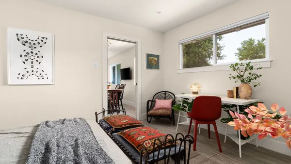 a living room with furniture and a potted plant