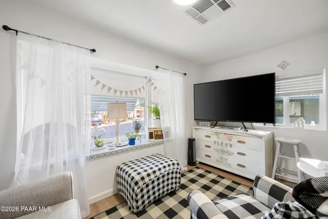 a bedroom with furniture and a flat screen tv