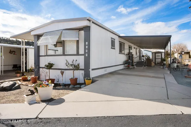 a view of a patio with dining table and chairs