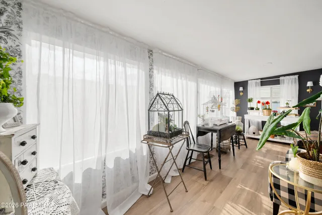 a dining room with furniture and a window
