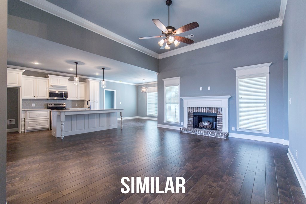 103 Timber Ridge Circle, Unit 139 Byron, GA 31008 - Photo 4 of 30 a view of an empty room with kitchen and fireplace