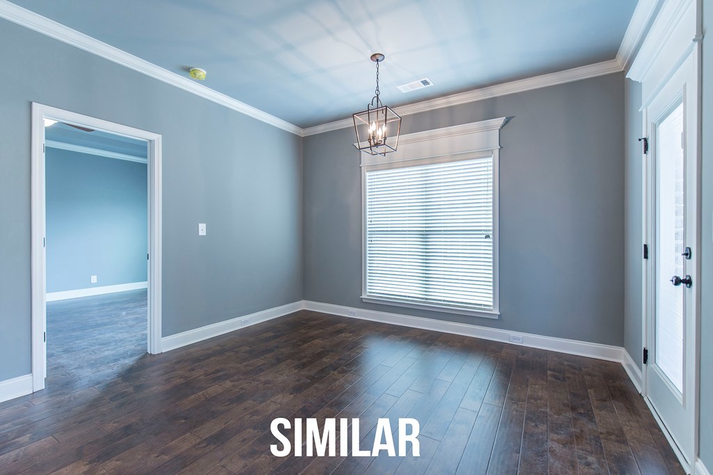 103 Timber Ridge Circle, Unit 139 Byron, GA 31008 - Photo 7 of 30 an empty room with wooden floor and windows