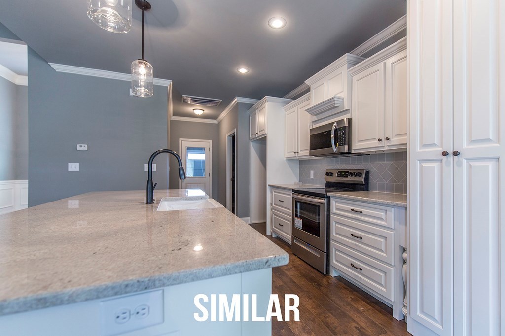 103 Timber Ridge Circle, Unit 139 Byron, GA 31008 - Photo 8 of 30 a kitchen with stainless steel appliances granite countertop a sink a stove and a refrigerator