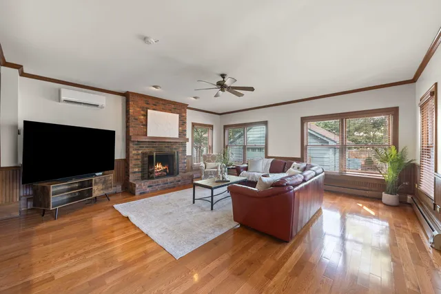a living room with furniture a flat screen tv and a fireplace