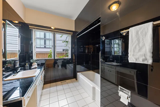 a living room with furniture a flat screen tv and large window