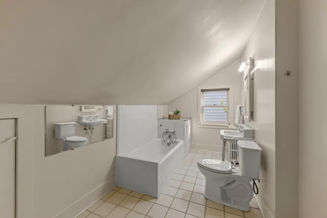 a bathroom with a sink a toilet and mirror