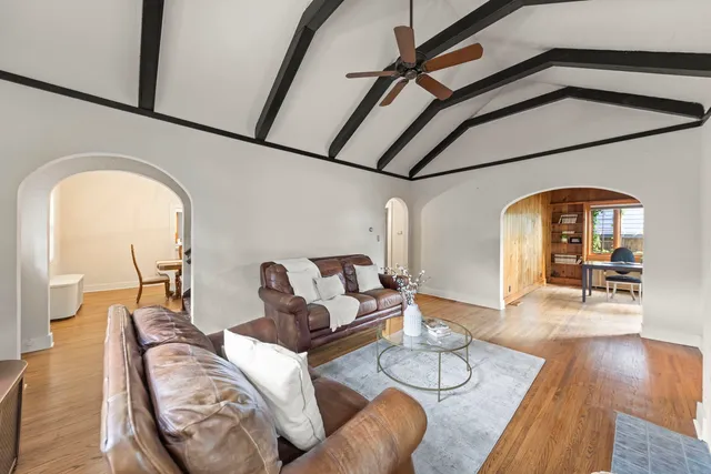 a living room with furniture and wooden floor