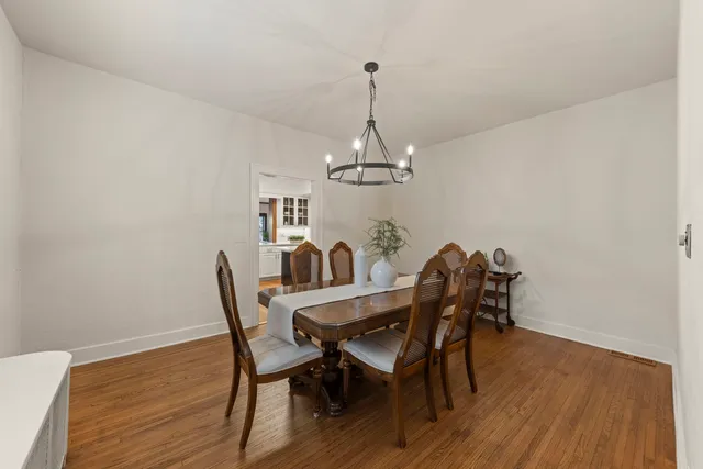 a view of a dining room with furniture wooden floor and chandelier