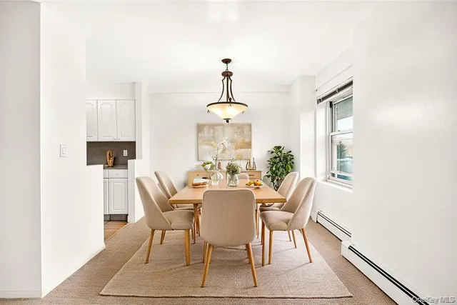 a dining room with furniture window and wooden floor