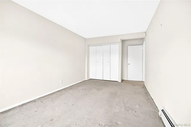 a utility room with dryer washer and a view of living room