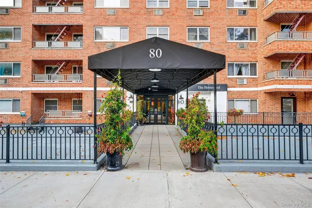 front view of a brick house with large windows
