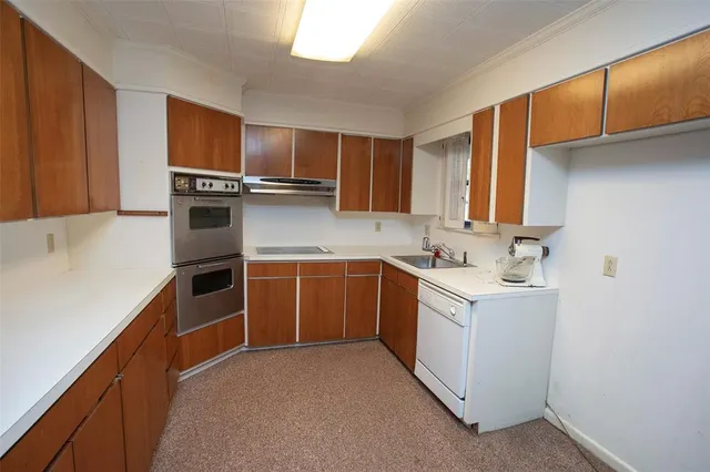 a kitchen with a sink stove and microwave