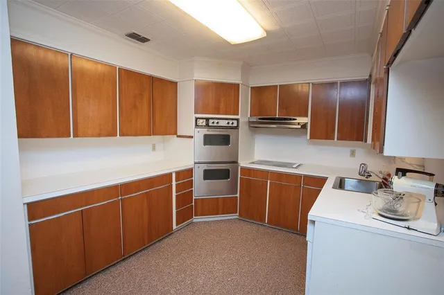 a kitchen with stainless steel appliances a sink stove and refrigerator