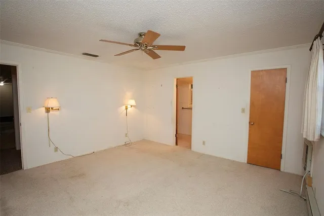 a view of a room with a ceiling fan
