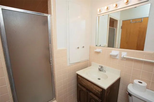 a bathroom with a sink a mirror and shower