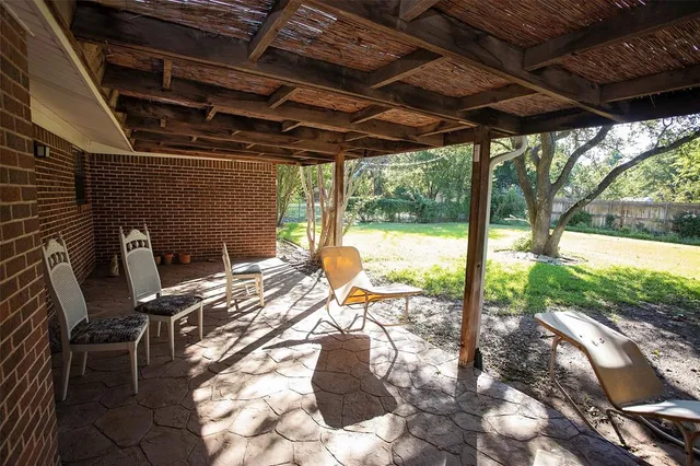 a view of a porch with furniture and backyard