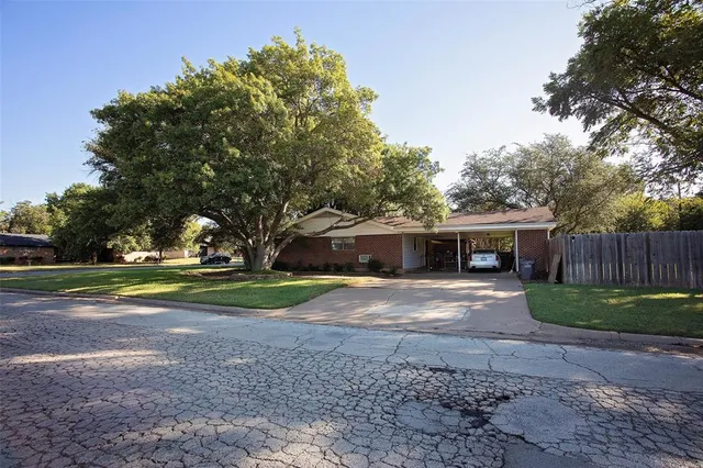 a front view of house with yard and trees