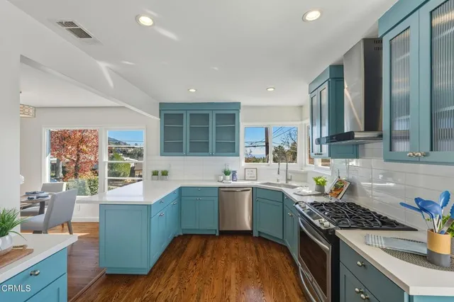 a kitchen with a sink stove and cabinets