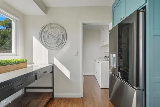 a kitchen with stainless steel appliances granite countertop a refrigerator a stove and a wooden floors