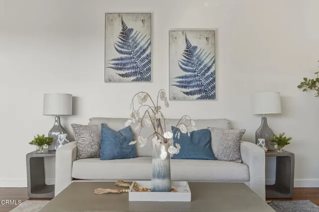 a living room with furniture and a potted plant