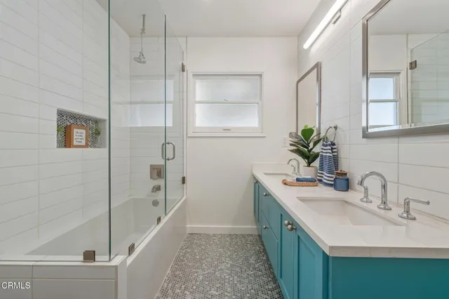 a bathroom with a double vanity sink and a bathtub