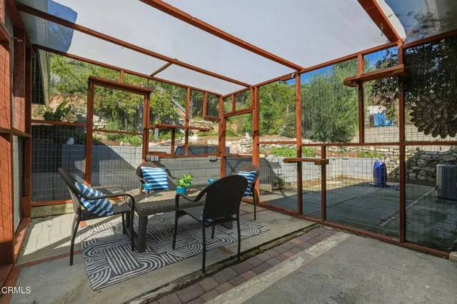 a balcony view with a table and chairs