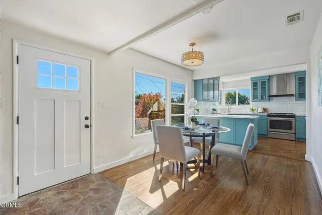 a view of a dining room with furniture window and wooden floor