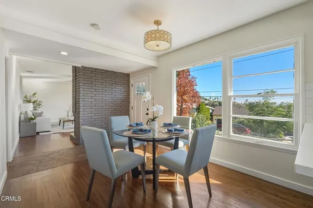 a view of a dining room with furniture window and wooden floor