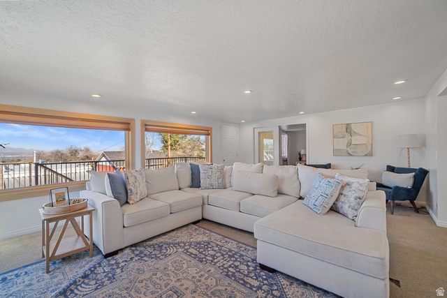 4426 South 3035 East Holladay, UT 84124 - Photo 12 of 49 Carpeted living area featuring a textured ceiling and recessed lighting